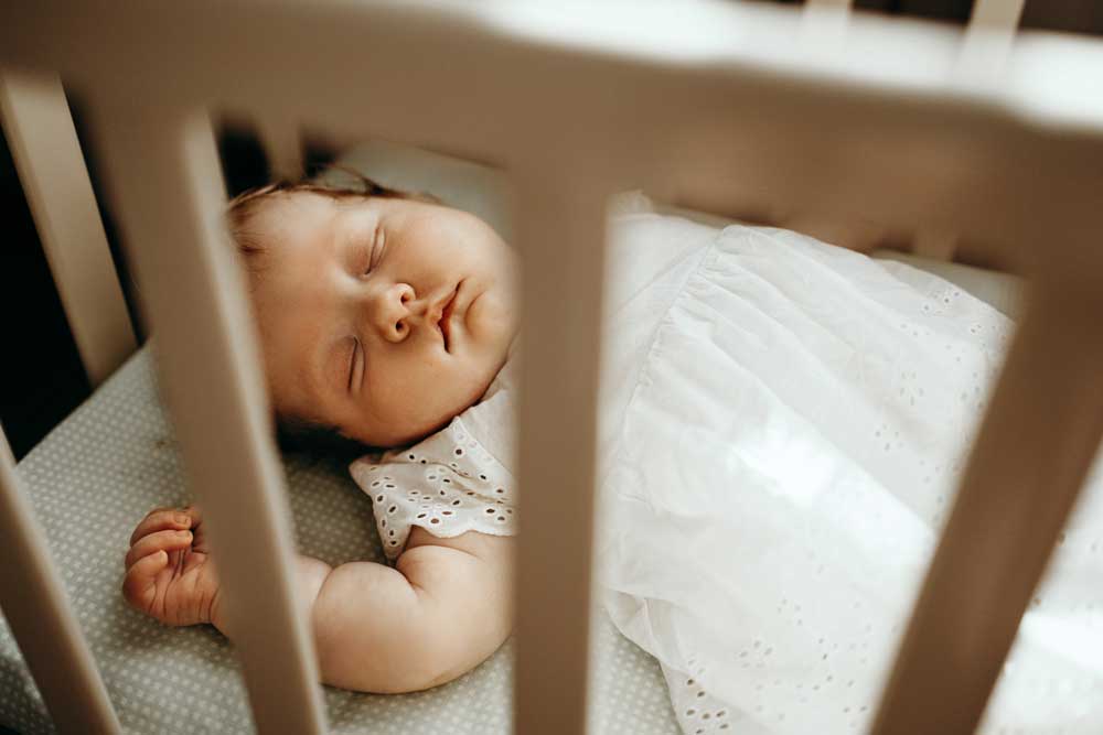baby sound asleep in her crib